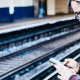 Tourist waiting on train platform looking at his mobile phone